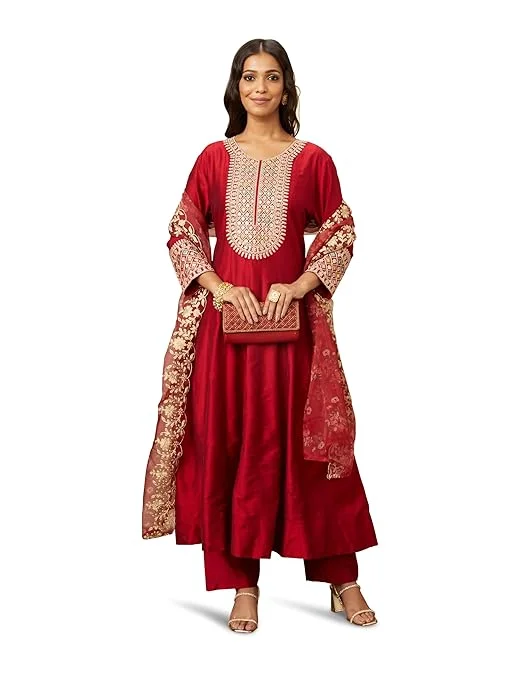 Woman wearing red embroidered Anarkali suit with matching organza dupatta and ethnic party wear design.